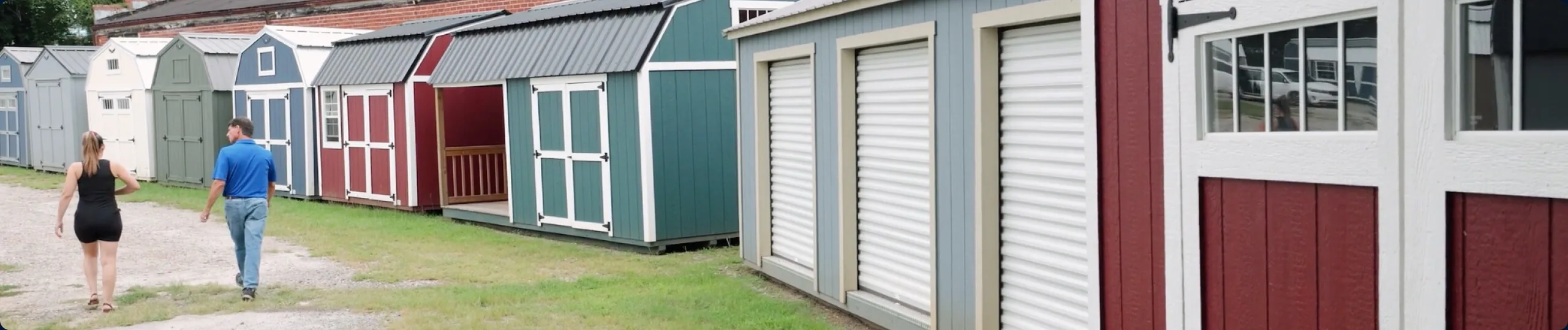Customers walking a dealer lot lined with finished sheds
