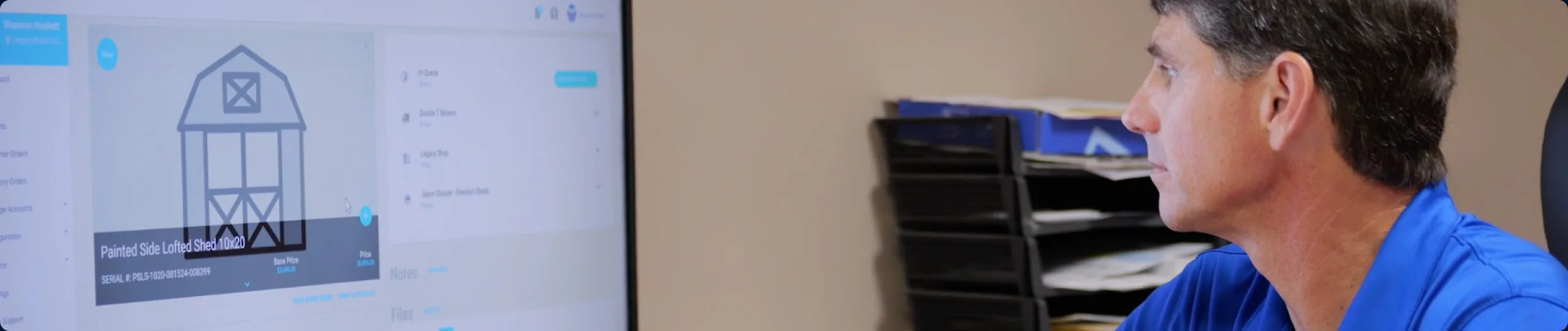 A Shed Suite user reviewing a shed order on screen at their desk