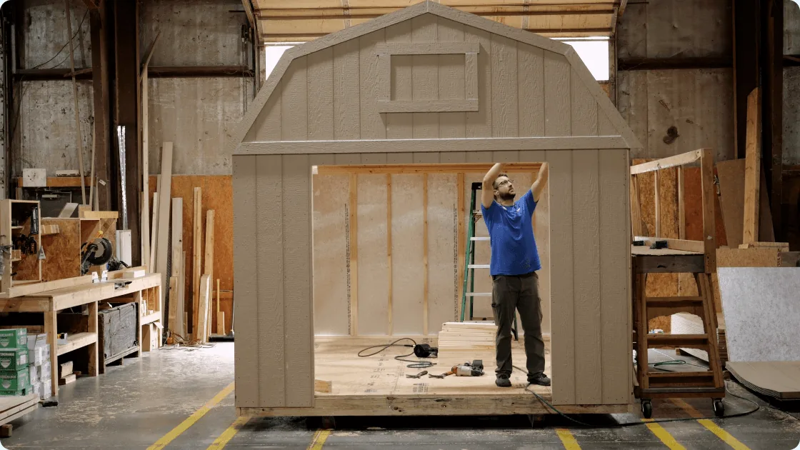 A Legacy Sheds team member building a shed in the shop