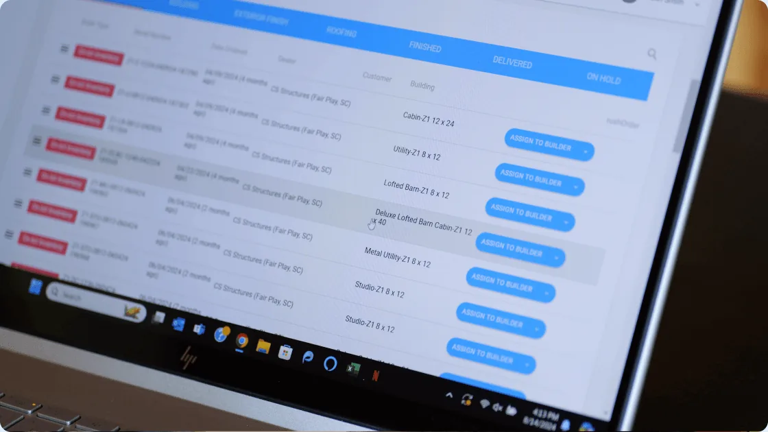 Shed Suite order management shown on a laptop screen