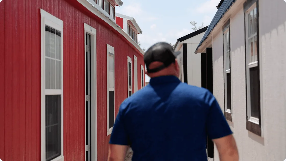 A Stor-Mor team member walking the shed sales lot