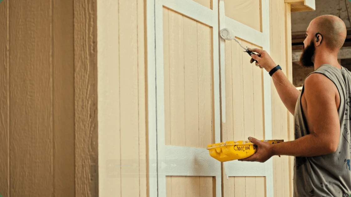 A Westwood Sheds builder painting trim in the Due West plant